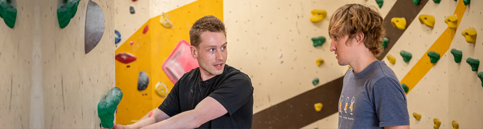 climber receiving coaching advice from Social Climbing staff